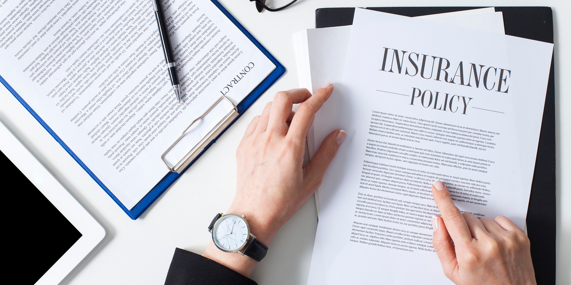 Reviewing contract and insurance documents on table